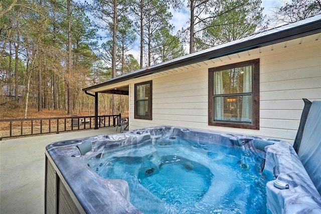 wooden deck with a hot tub