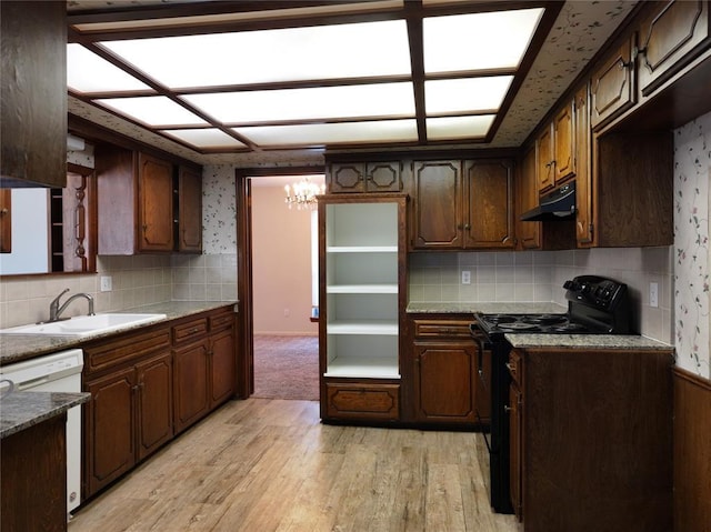 kitchen featuring under cabinet range hood, electric range, a sink, light stone countertops, and dishwasher