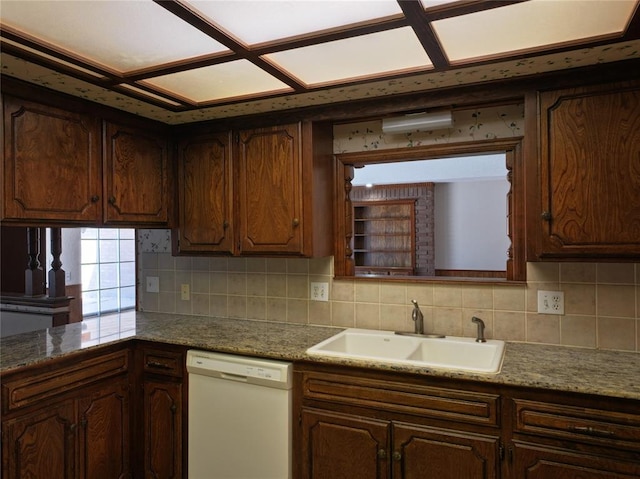 kitchen featuring dishwasher, dark brown cabinets, a sink, and decorative backsplash