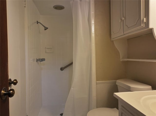 full bathroom with a stall shower, vanity, and toilet