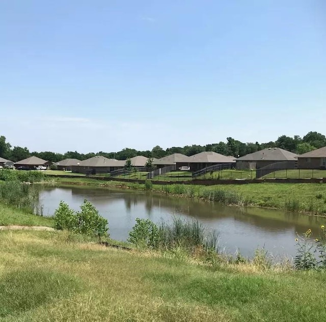 water view with a residential view and fence