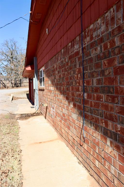 view of side of home featuring brick siding