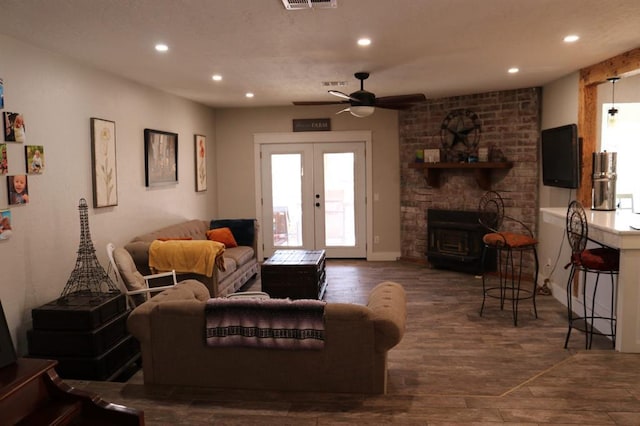 living room featuring recessed lighting, french doors, visible vents, and wood finished floors