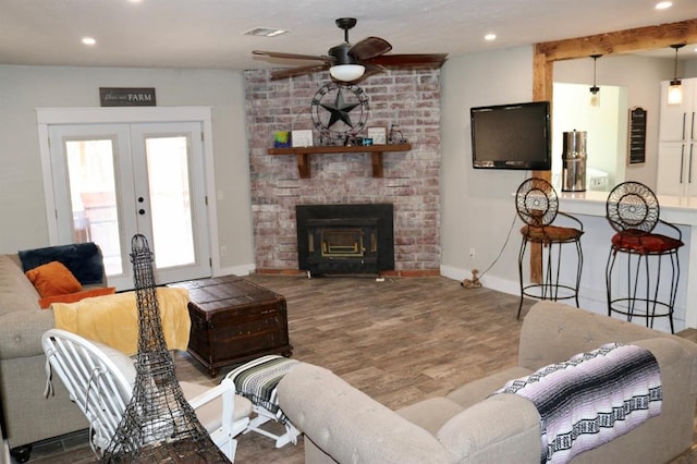 living room featuring recessed lighting, wood finished floors, visible vents, and french doors