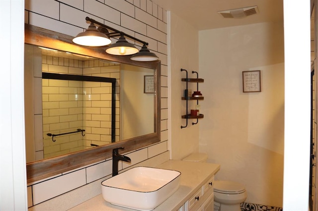 full bathroom with visible vents, toilet, decorative backsplash, vanity, and a shower