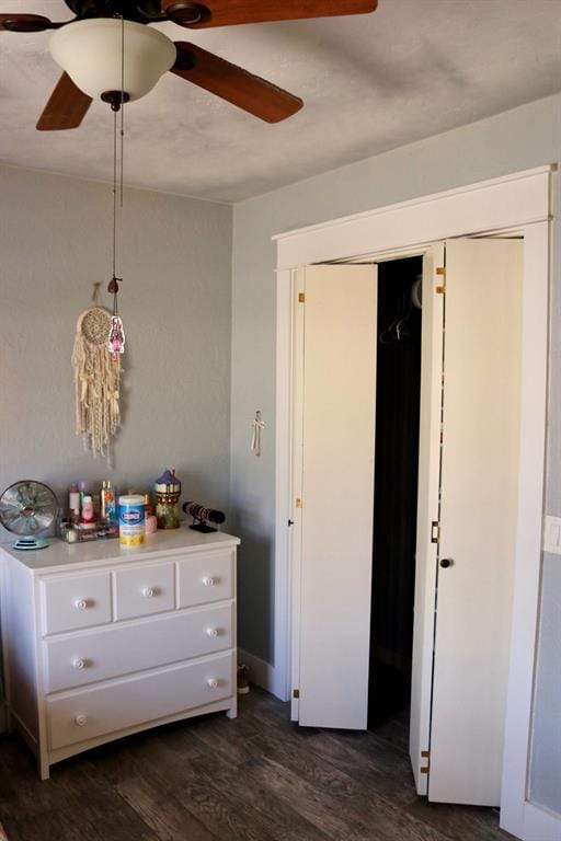 unfurnished bedroom featuring a closet, dark wood-type flooring, and ceiling fan