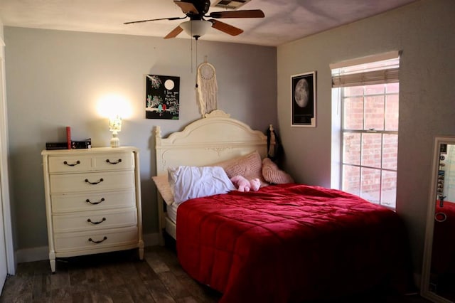 bedroom featuring ceiling fan, visible vents, baseboards, and dark wood finished floors