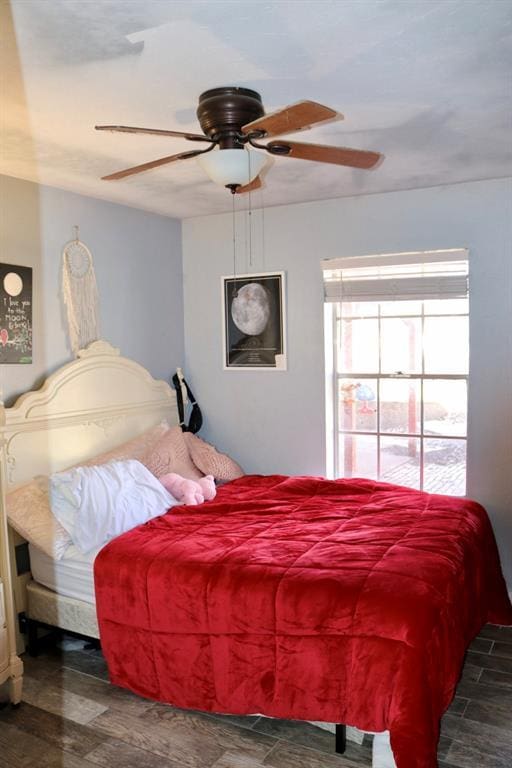 bedroom featuring a ceiling fan and wood finished floors