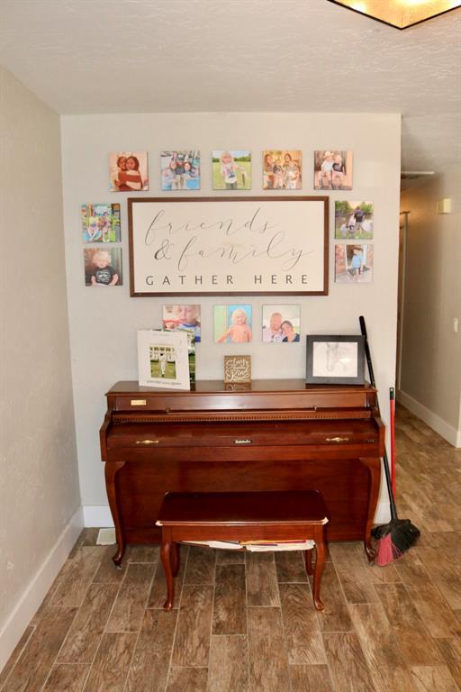 interior details featuring baseboards and wood tiled floor