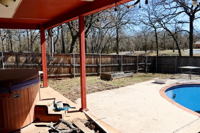 exterior space with a fenced backyard, a patio area, a vegetable garden, a fenced in pool, and a hot tub