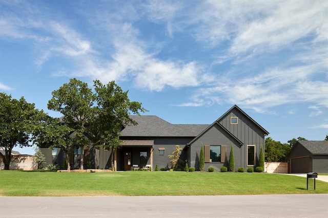 modern farmhouse featuring a front lawn and board and batten siding