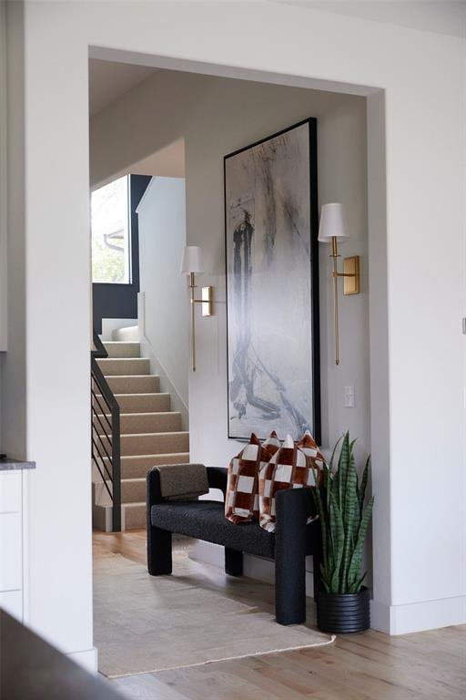 interior space with light wood-style flooring and stairs