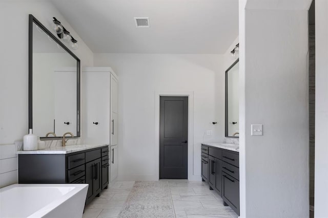 bathroom with two vanities, visible vents, and a sink