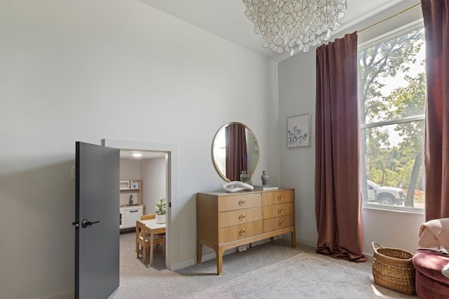 bedroom with light carpet and baseboards