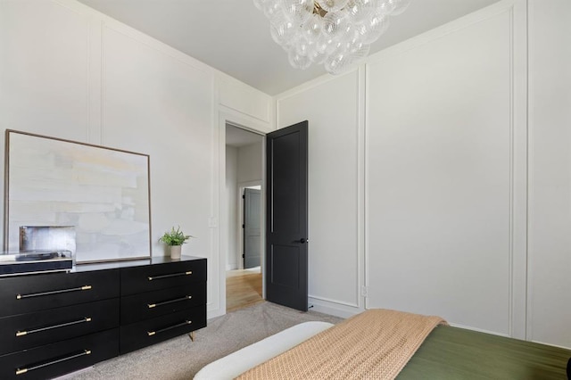 bedroom featuring light carpet and a decorative wall