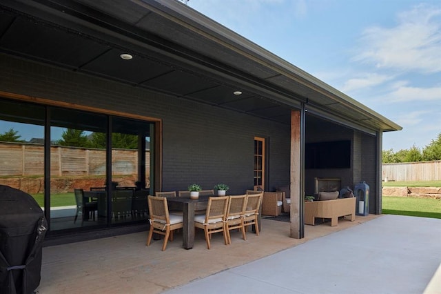 view of patio featuring fence, outdoor dining area, and area for grilling