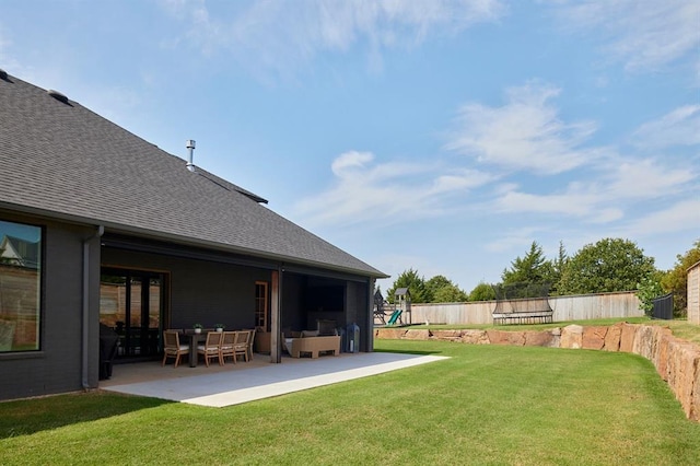 view of yard with a patio area, a playground, and a fenced backyard