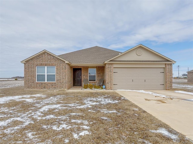 ranch-style home featuring a garage, driveway, brick siding, and a shingled roof