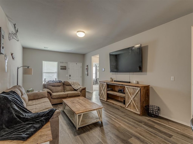 living room featuring baseboards and wood finished floors