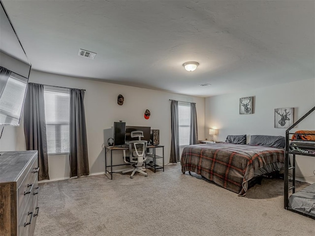 bedroom with light colored carpet, visible vents, and baseboards