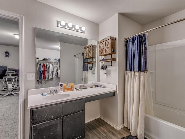 full bathroom featuring wood finished floors, vanity, and shower / bathtub combination with curtain