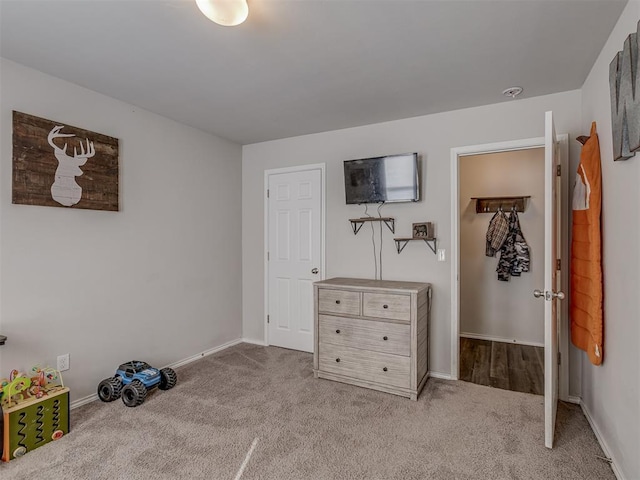 unfurnished bedroom featuring light carpet and baseboards