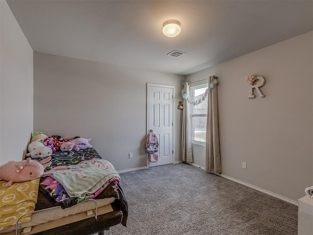 carpeted bedroom featuring visible vents and baseboards