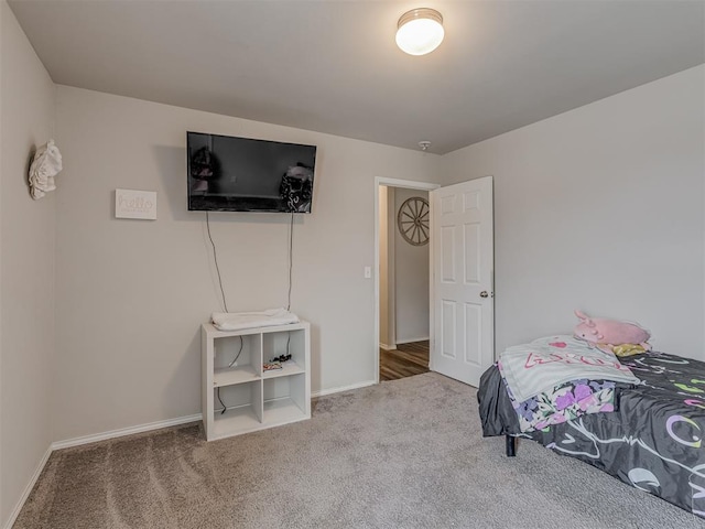 bedroom with carpet flooring and baseboards