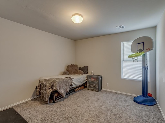 bedroom with light colored carpet, visible vents, and baseboards