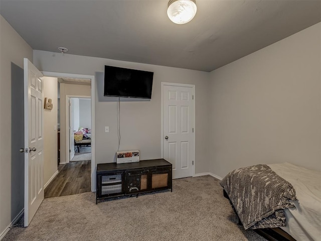 carpeted bedroom featuring baseboards