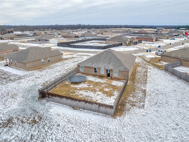 snowy aerial view with a residential view