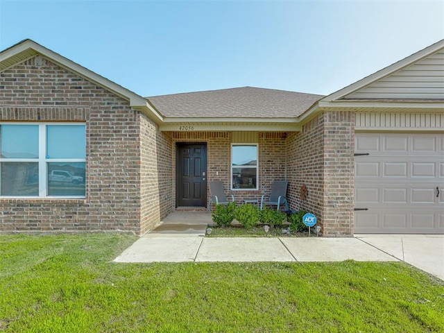 42056 Cadens Trl, Shawnee, OK 74804 - entrance to property featuring brick siding, a yard, a garage, and a shingled roof