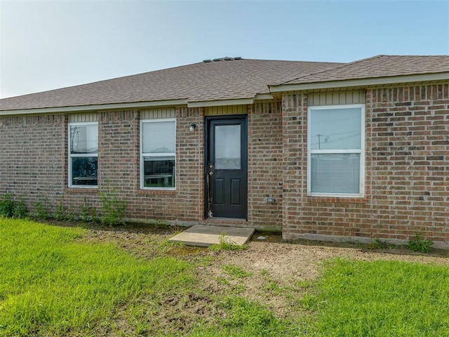 42056 Cadens Trl, Shawnee, OK 74804 - property entrance featuring a yard, brick siding, and roof with shingles