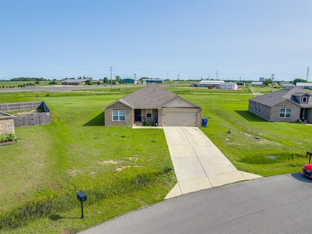 42056 Cadens Trl, Shawnee, OK 74804 - view of front of house featuring a garage, driveway, a front yard, and brick siding