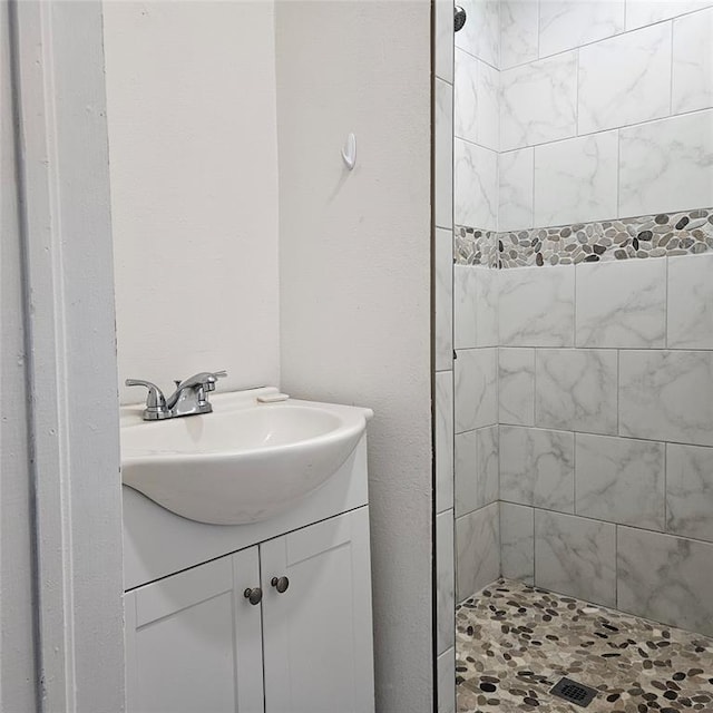 full bathroom featuring a stall shower and vanity