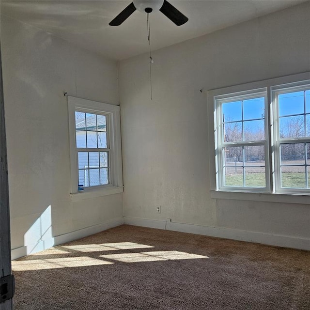 unfurnished room featuring carpet floors, plenty of natural light, and baseboards