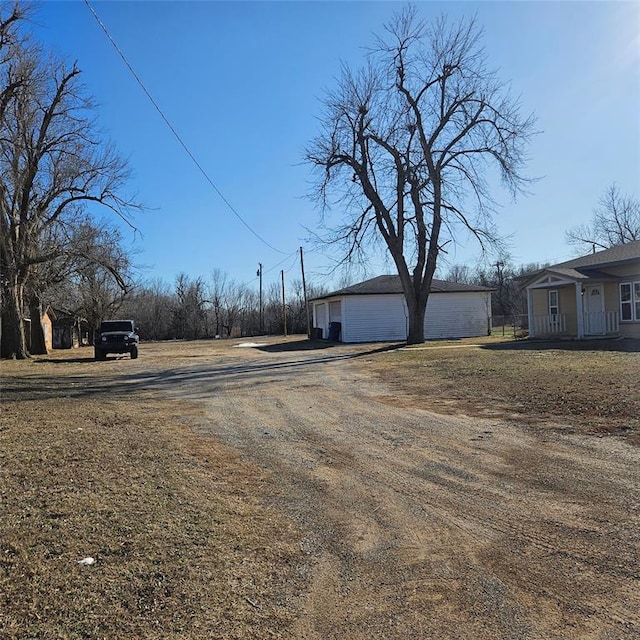 view of street with dirt driveway