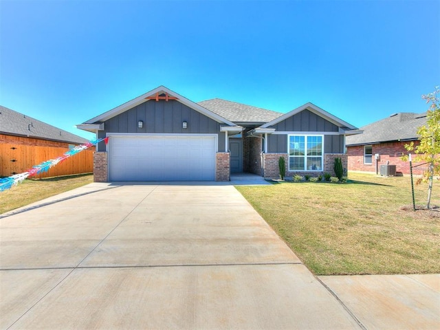 craftsman-style house with an attached garage, central air condition unit, brick siding, board and batten siding, and a front yard