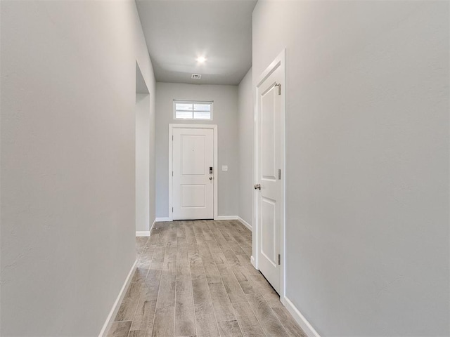 entryway with light wood-type flooring, visible vents, and baseboards