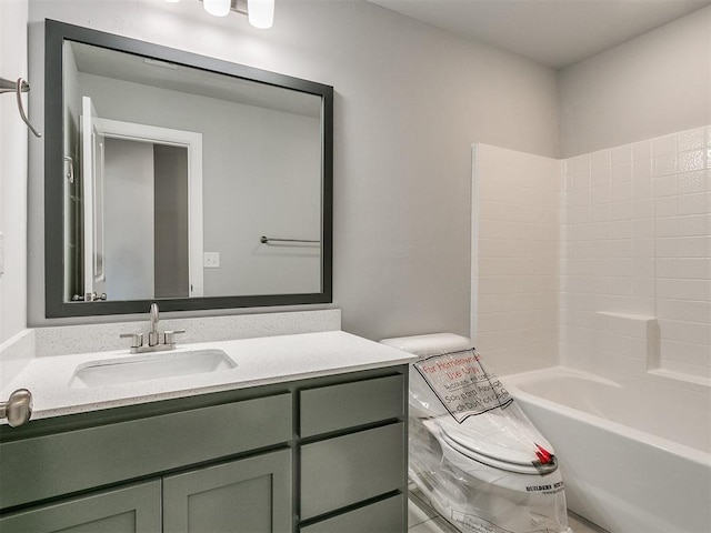 bathroom featuring toilet, washtub / shower combination, and vanity