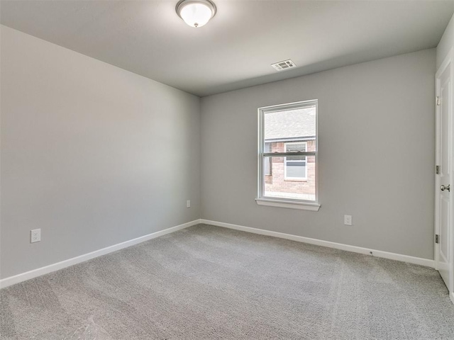 unfurnished room with baseboards, visible vents, and carpet flooring