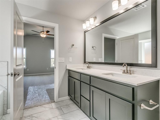 bathroom featuring marble finish floor, visible vents, a sink, and double vanity