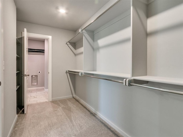 spacious closet with light carpet