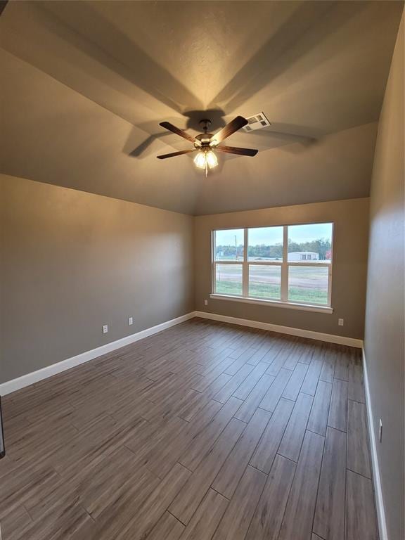1525 NW 17th Pl, Newcastle, OK 73065 - empty room featuring visible vents, lofted ceiling, baseboards, a ceiling fan, and dark wood finished floors