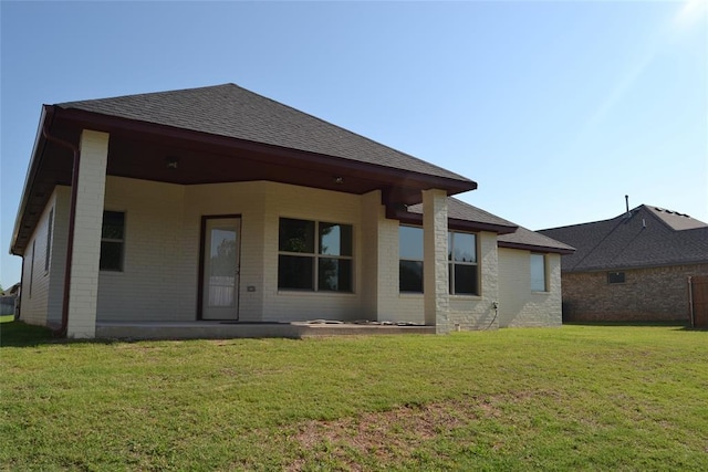 1525 NW 17th Pl, Newcastle, OK 73065 - rear view of property featuring a lawn, a shingled roof, and brick siding