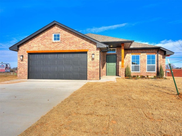 view of front of home with concrete driveway, brick siding, and roof with shingles