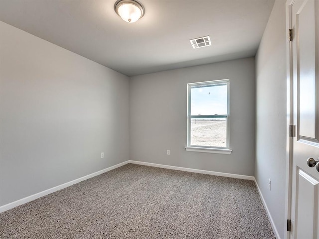 carpeted empty room featuring visible vents and baseboards