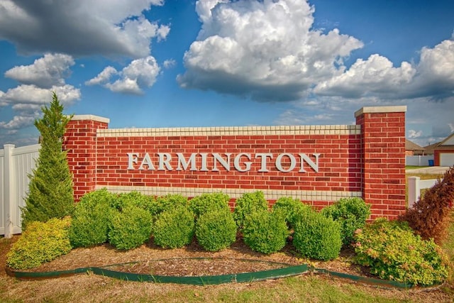 community sign featuring fence