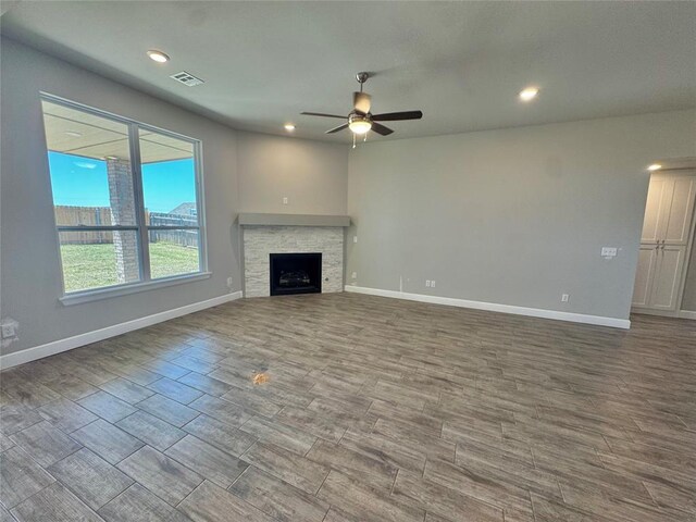 unfurnished living room with baseboards, visible vents, recessed lighting, wood finished floors, and ceiling fan