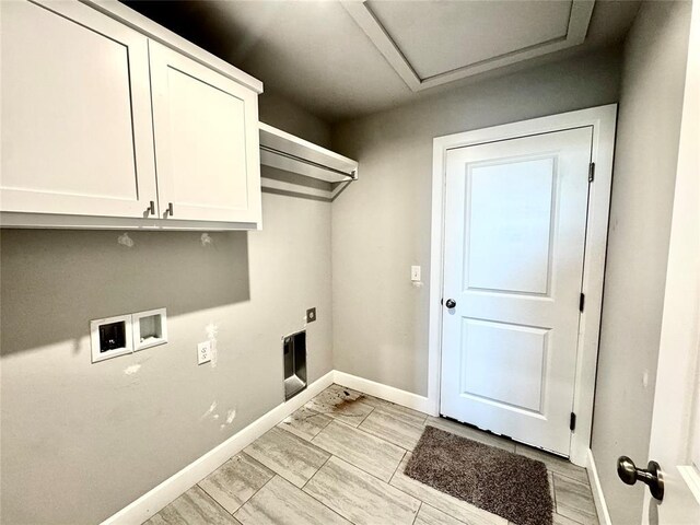 laundry area featuring hookup for a washing machine, attic access, hookup for an electric dryer, cabinet space, and baseboards